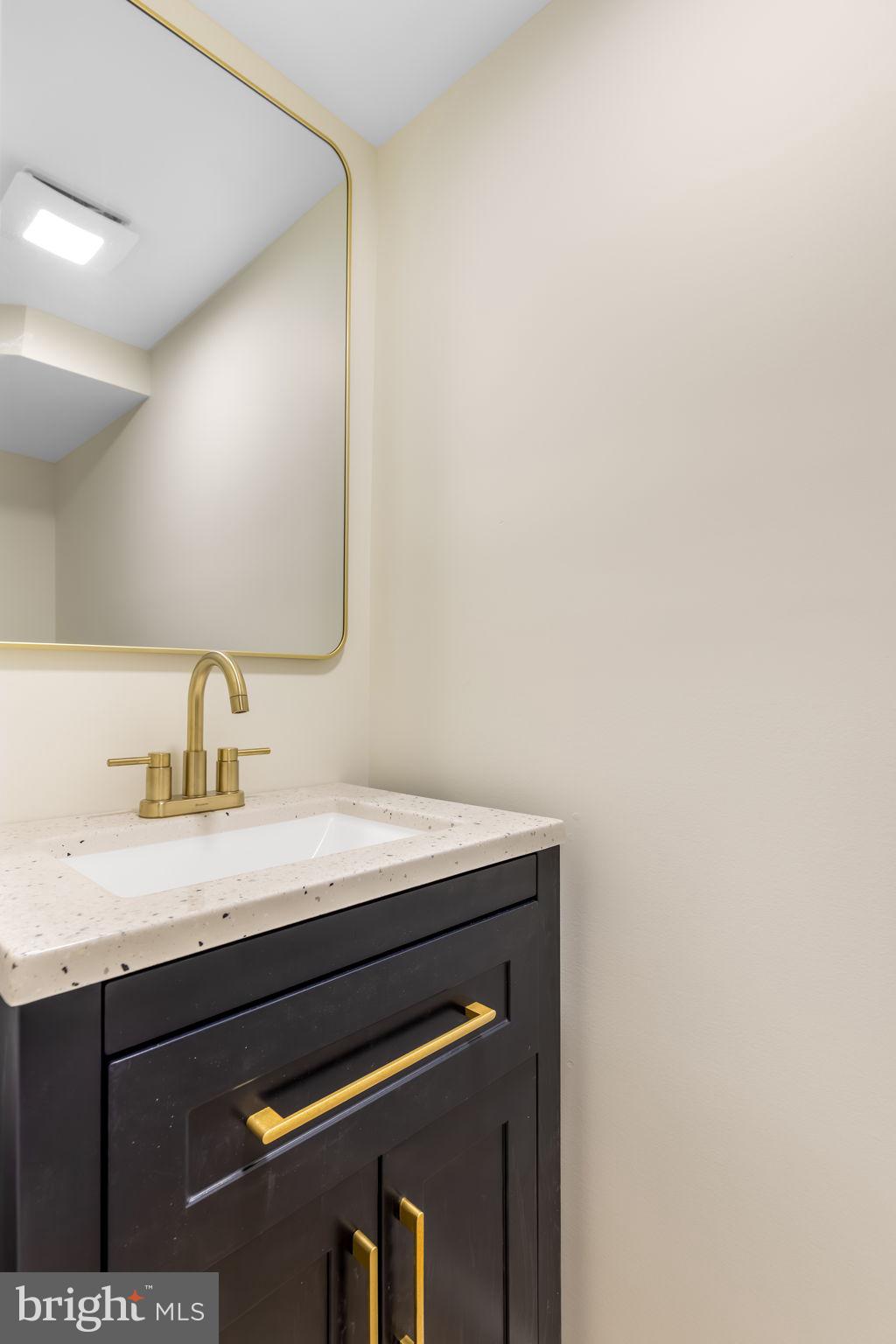 8371 Luce Court Springfield, VA 22153 - Photo 18 of 21 a bathroom with a sink and a mirror