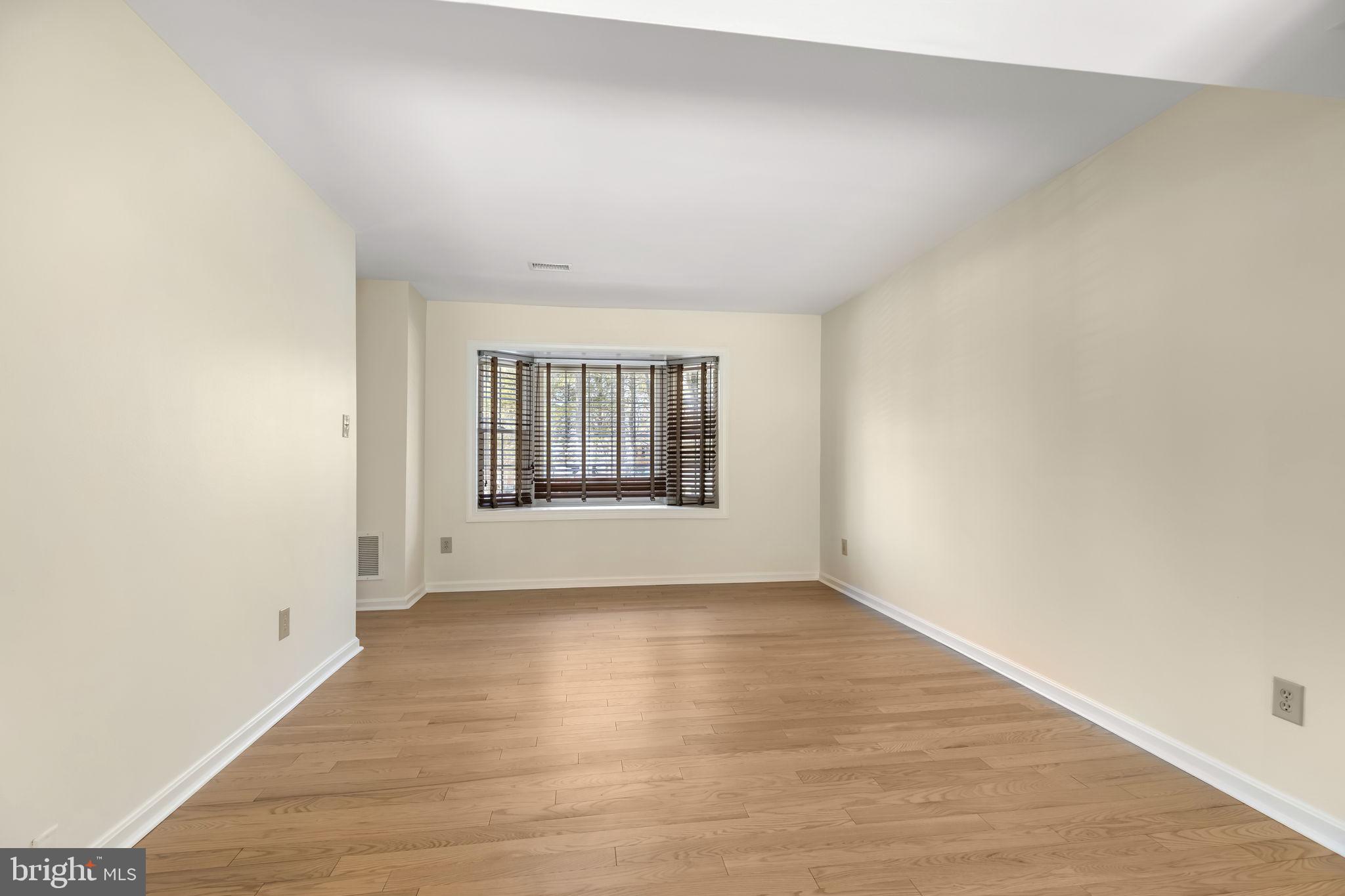 8371 Luce Court Springfield, VA 22153 - Photo 2 of 21 an empty room with wooden floor and windows