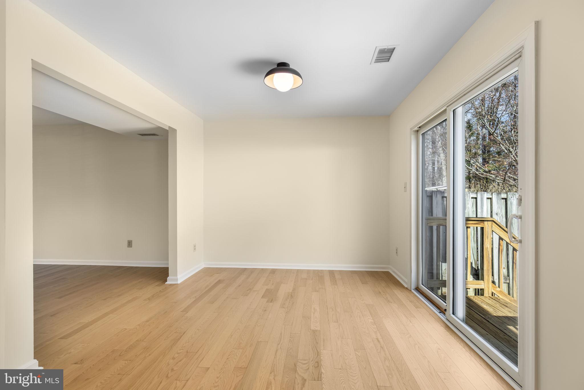 8371 Luce Court Springfield, VA 22153 - Photo 4 of 21 wooden floor in an empty room with a window