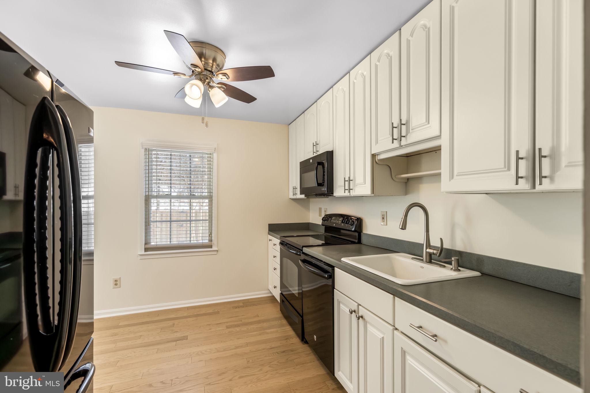 8371 Luce Court Springfield, VA 22153 - Photo 9 of 21 a kitchen with stainless steel appliances granite countertop a sink a stove and a refrigerator