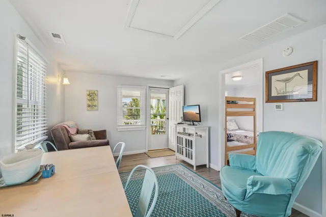 a kitchen with stainless steel appliances granite countertop a refrigerator a stove top oven a sink dishwasher and wooden floor