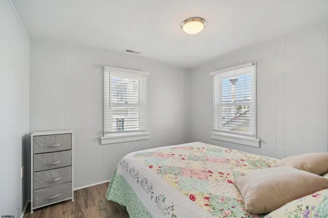 a bedroom with a bed and a lamp