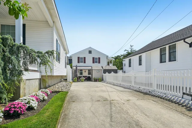 a view of a patio with couches table and chairs and potted plants