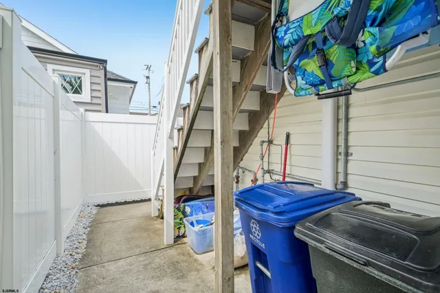 a view of outdoor sitting area with furniture and wooden fence