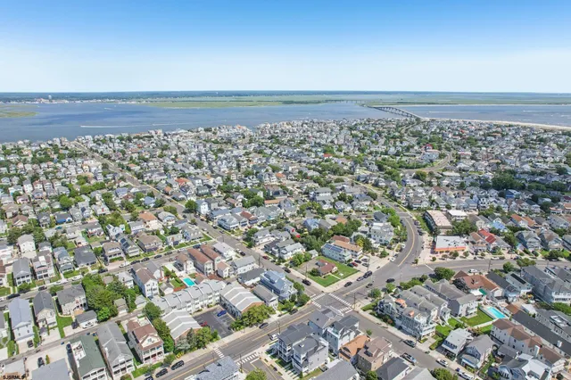 an aerial view of residential houses with outdoor space and parking