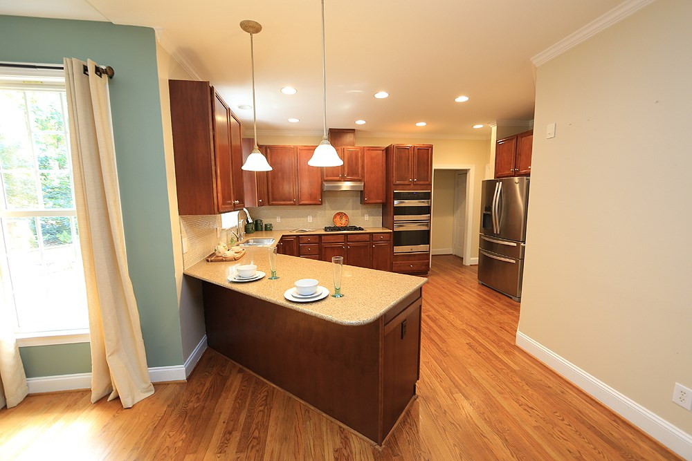 5921 Wild Orchid Trail Raleigh, NC 27613 - Photo 14 of 30 Updated kitchen with quartz counters, tiled backsplash, newer appliances. Kitchen