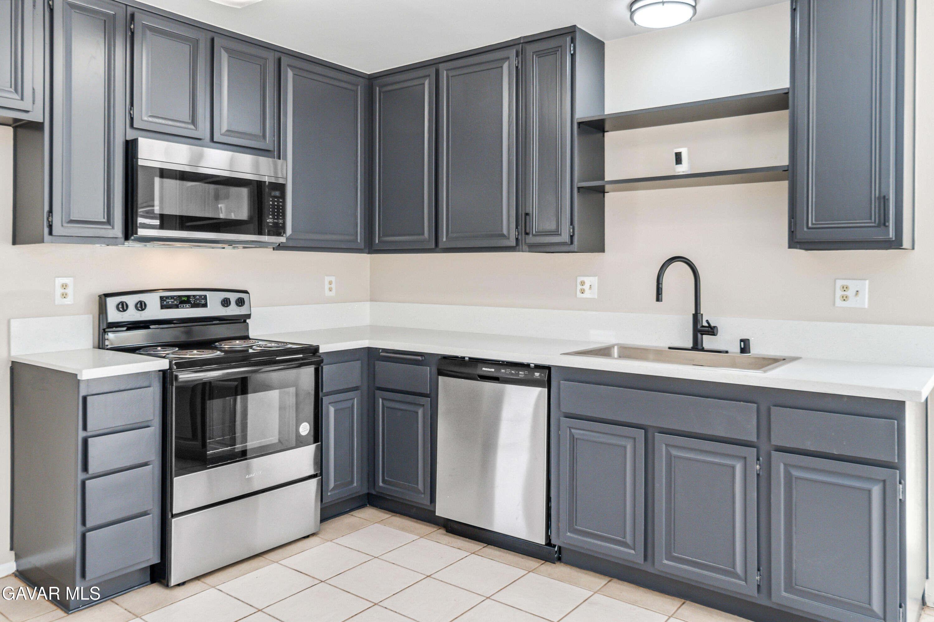 1027 Caperton Street Lancaster, CA 93535 - Photo 11 of 30 a kitchen with stainless steel appliances granite countertop a sink stove and microwave