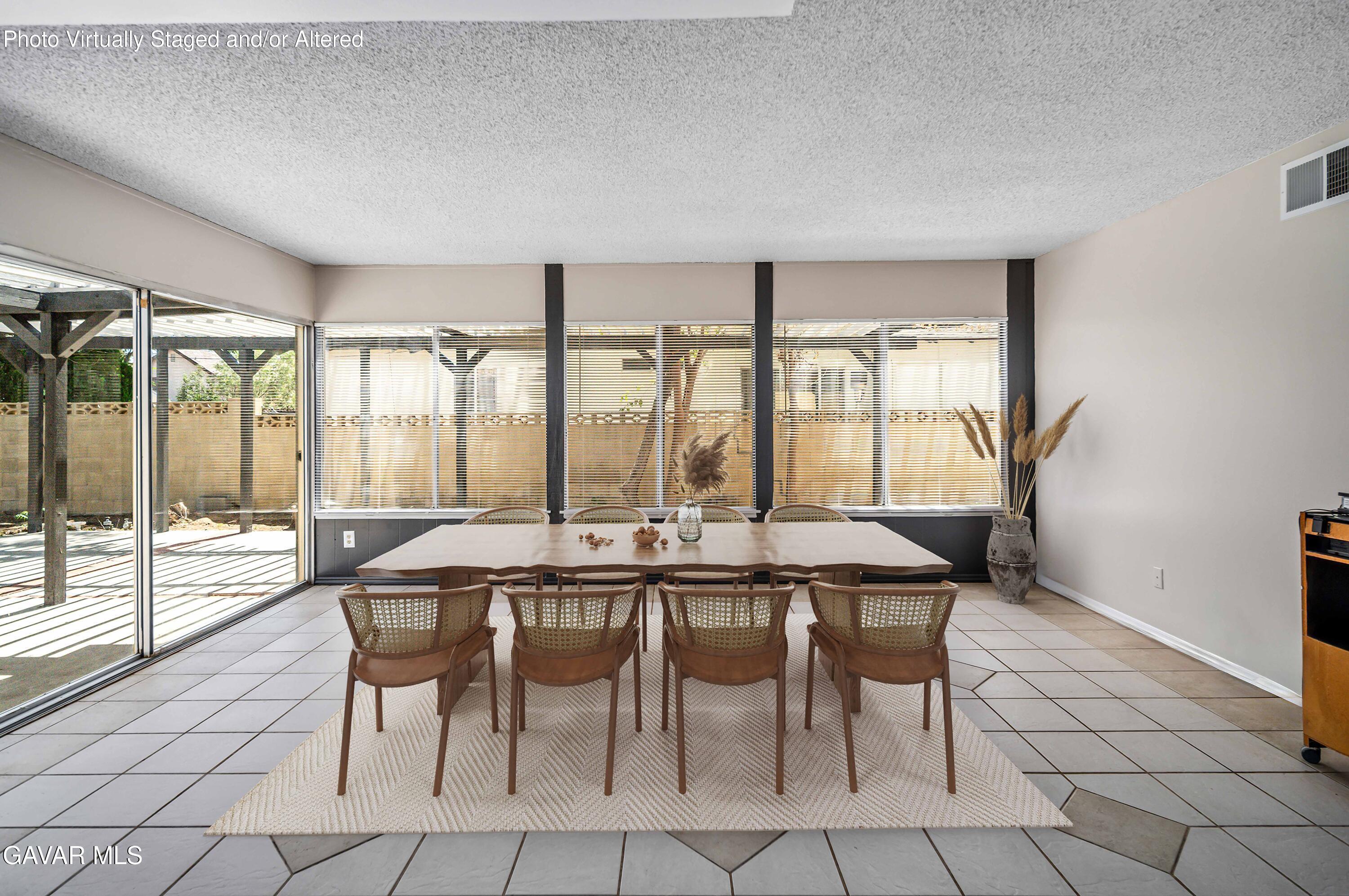1027 Caperton Street Lancaster, CA 93535 - Photo 14 of 30 a dining room with furniture and large windows