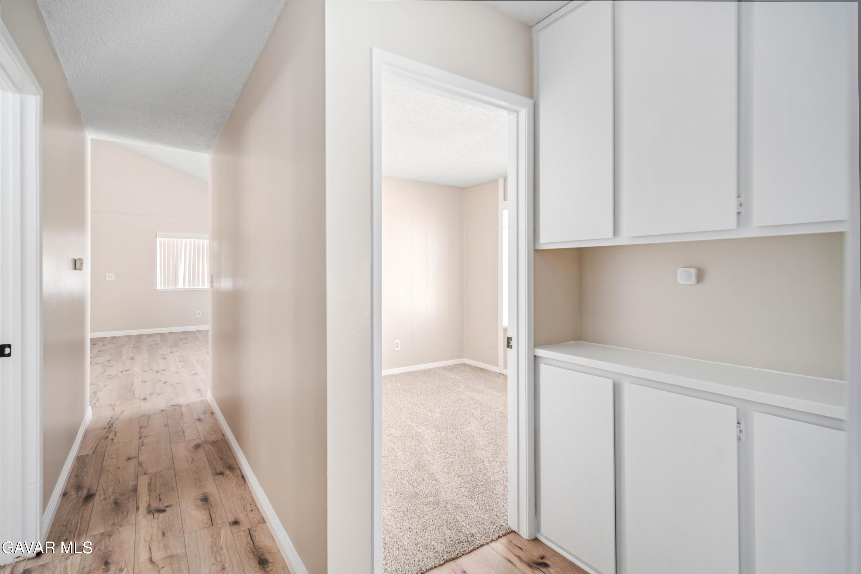 1027 Caperton Street Lancaster, CA 93535 - Photo 16 of 30 wooden floor with cabinet in hallway