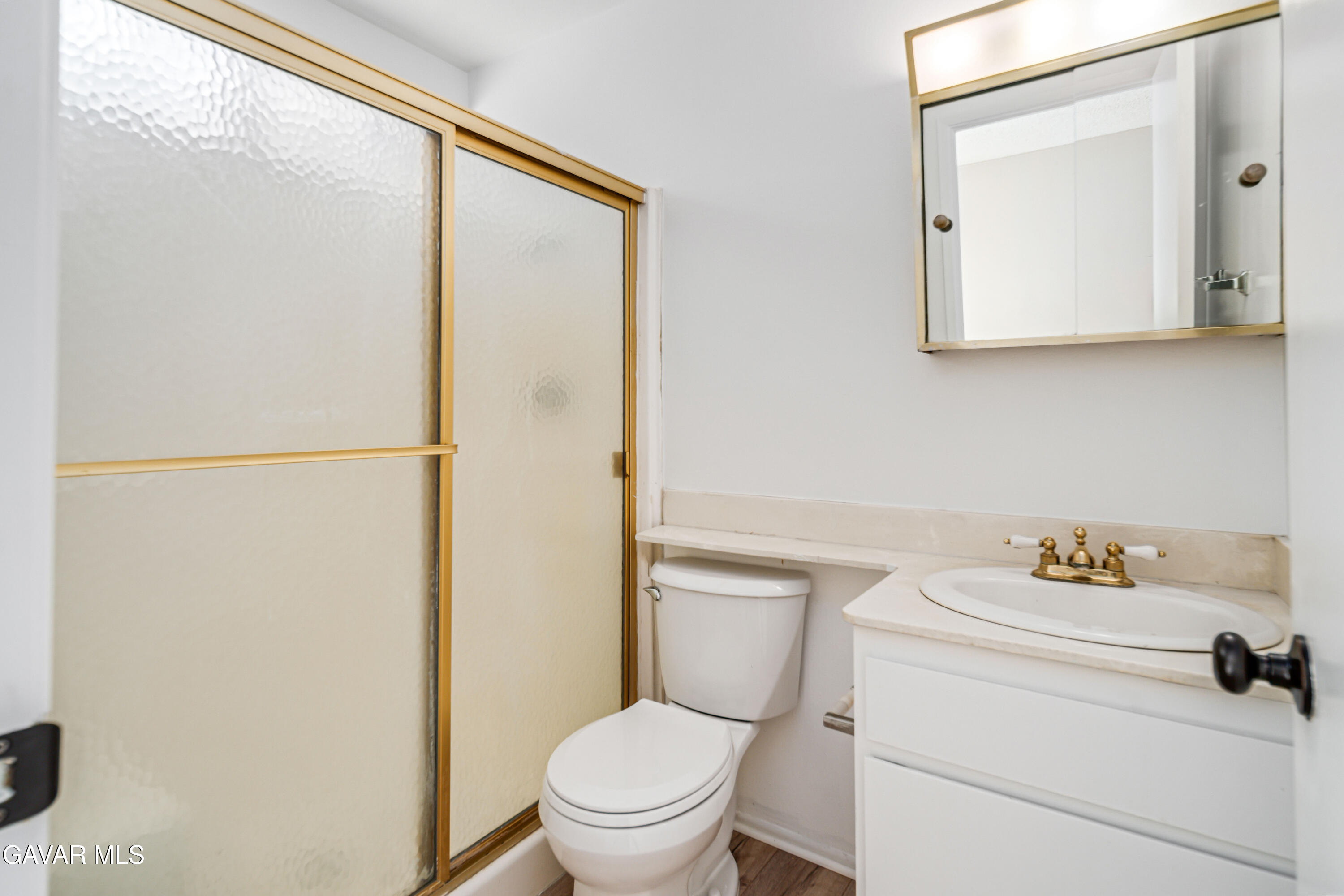 1027 Caperton Street Lancaster, CA 93535 - Photo 20 of 30 a white toilet sitting next to a bathroom sink