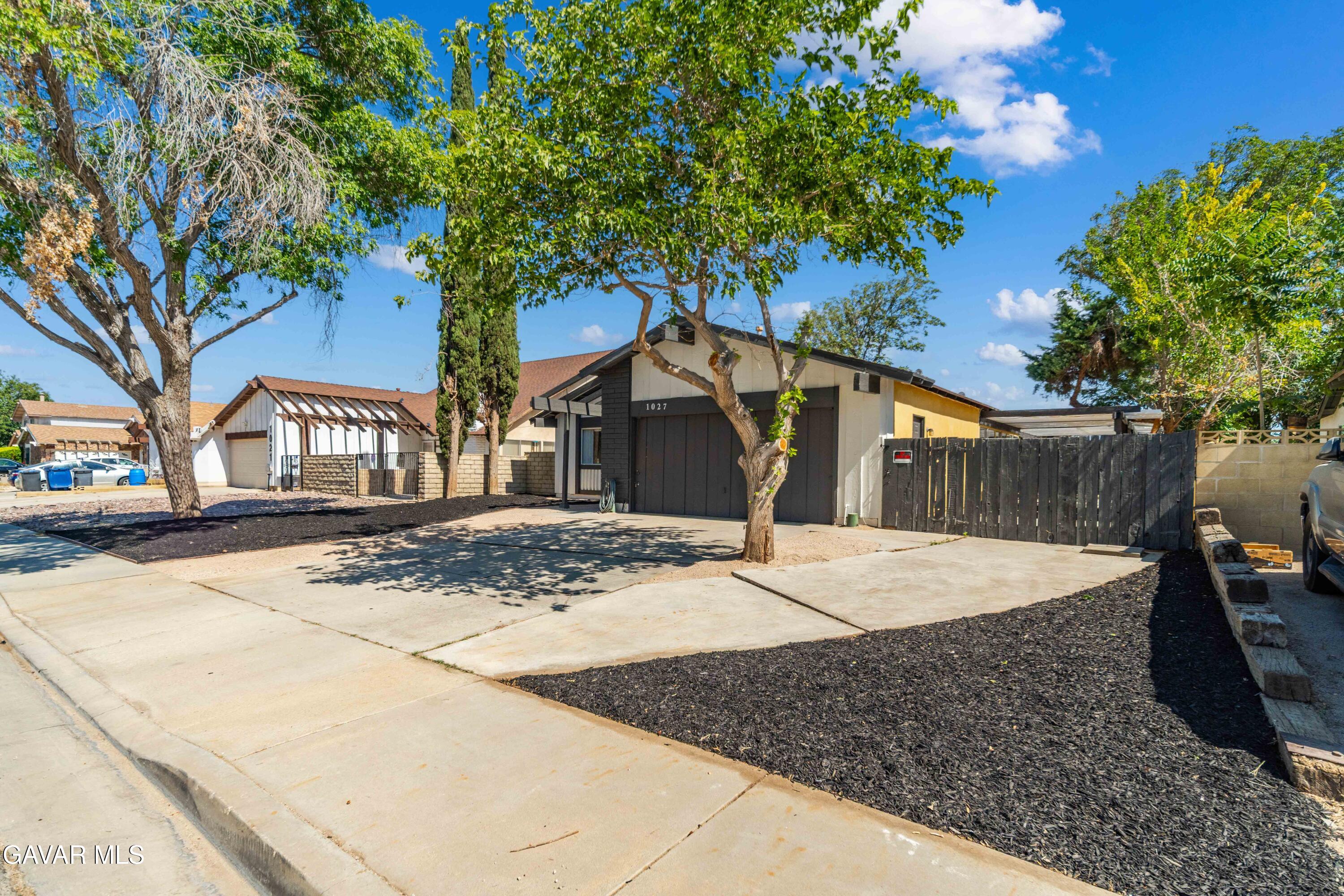 1027 Caperton Street Lancaster, CA 93535 - Photo 2 of 30 a view of a house with a tree next to a yard