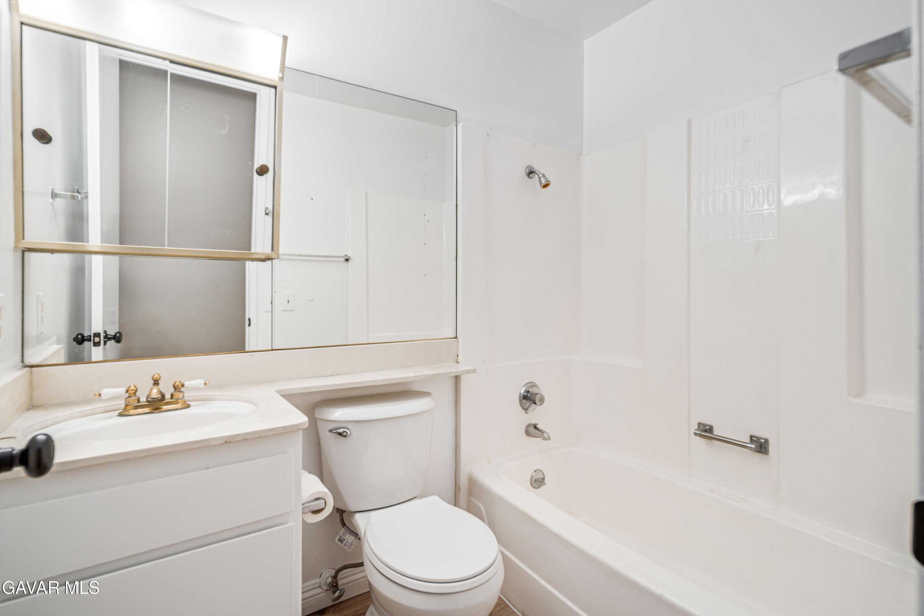 1027 Caperton Street Lancaster, CA 93535 - Photo 24 of 30 a bathroom with a sink toilet vanity and shower