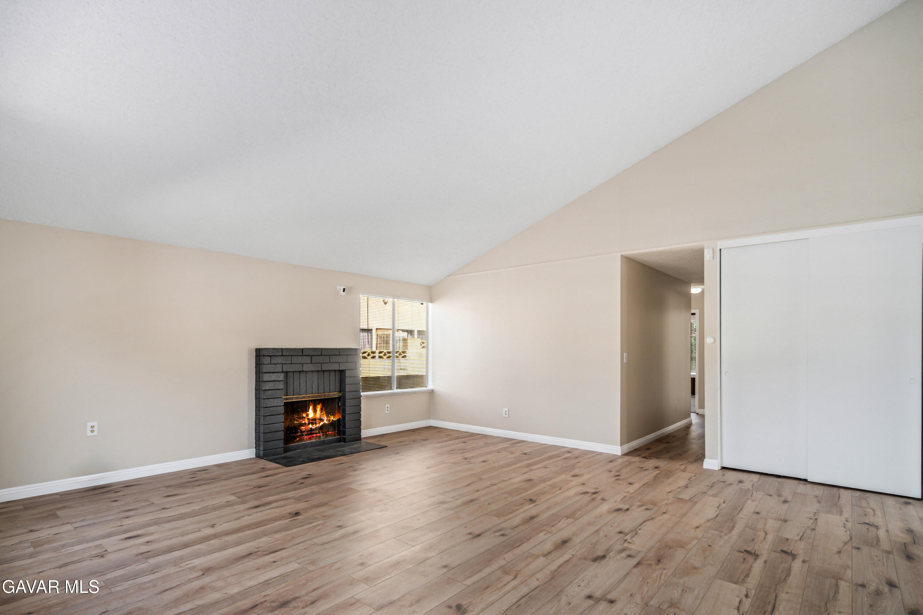 1027 Caperton Street Lancaster, CA 93535 - Photo 4 of 30 a view of empty room with a fireplace and wooden floor