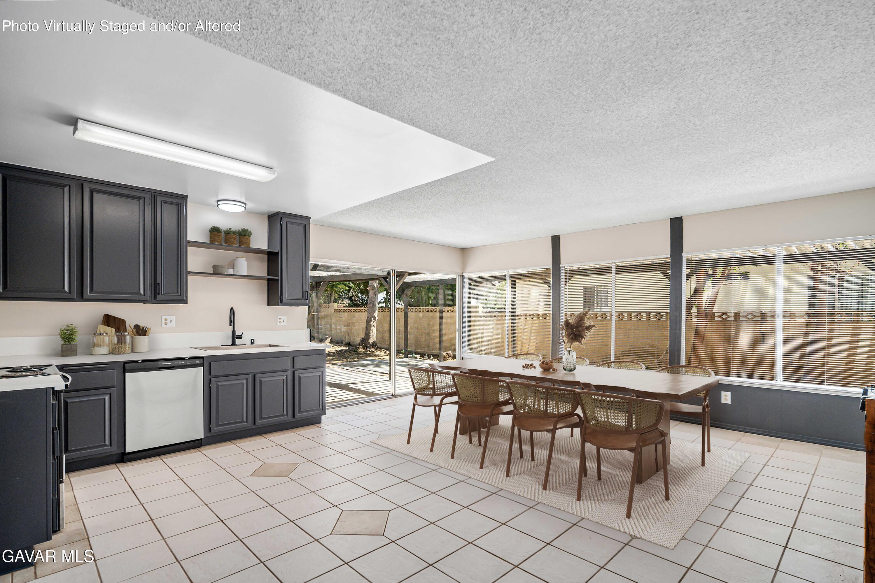 1027 Caperton Street Lancaster, CA 93535 - Photo 9 of 30 a large kitchen with a table and chairs