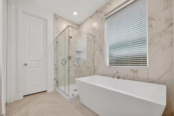 a bathroom with a bathtub and a shower