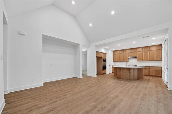a view of kitchen and a sink with wooden floor