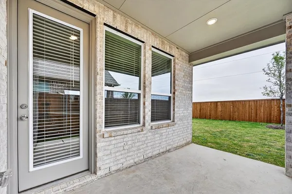 a view of a porch with a door and a chair