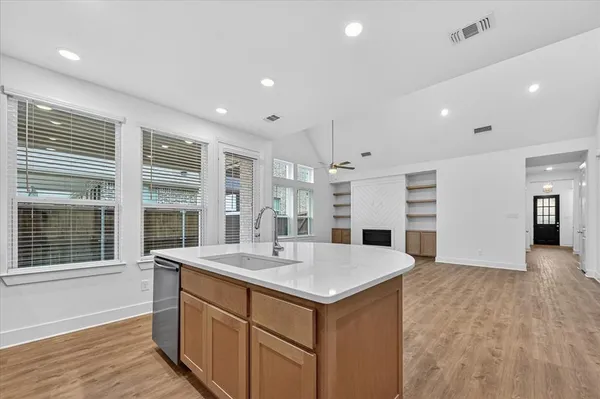 a large white kitchen with a large window