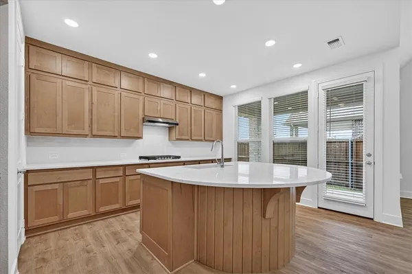 a kitchen with stainless steel appliances granite countertop a sink a stove and a refrigerator