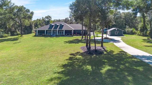 a kitchen with stainless steel appliances a stove a sink and white cabinets with wooden floor