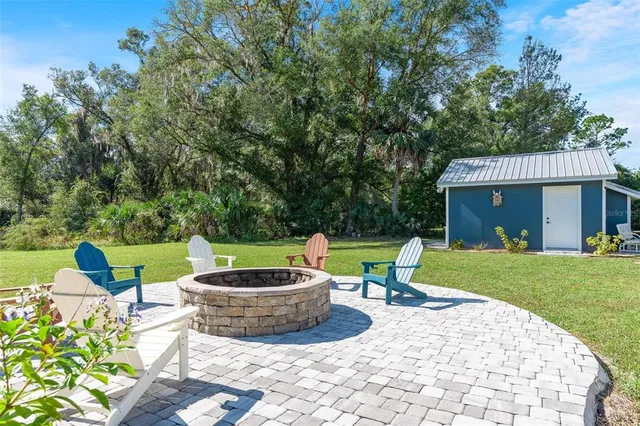an aerial view of house with yard and mountain view in back