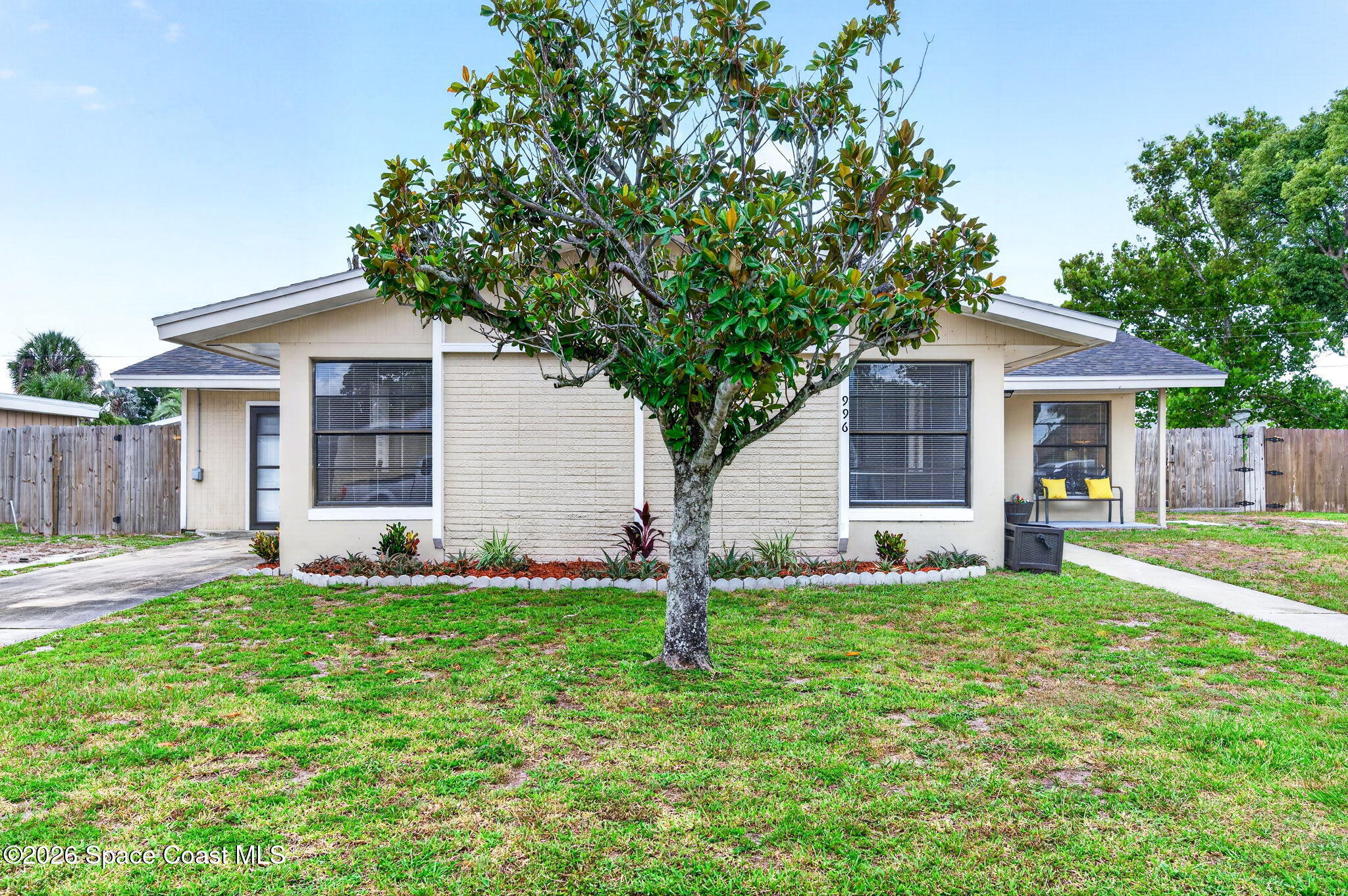 996 Botany Lane Rockledge, FL 32955 - Photo 3 of 35 a front view of a house with a yard and garage