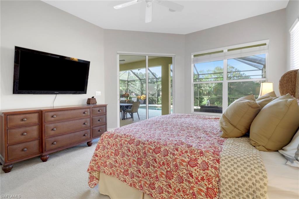 6757 Bent Grass Drive Naples, FL 34113 - Photo 13 of 27 a bedroom with a large bed and a flat screen tv