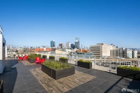 a view of city from terrace along with seating space and barbeque oven