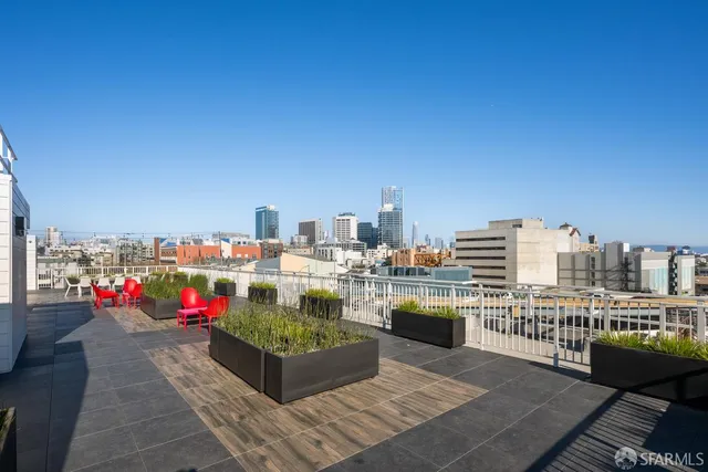 a view of city from terrace along with seating space and barbeque oven