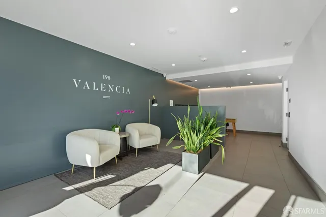 a view of a lobby area with furniture and wooden floor
