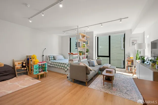 a living room with furniture and a wooden floor