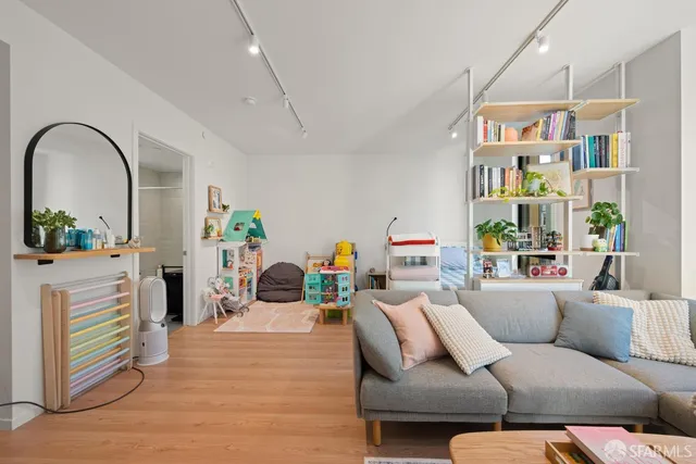 a living room with furniture and a chandelier