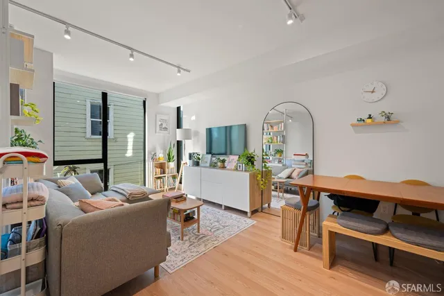 a living room with furniture and wooden floor