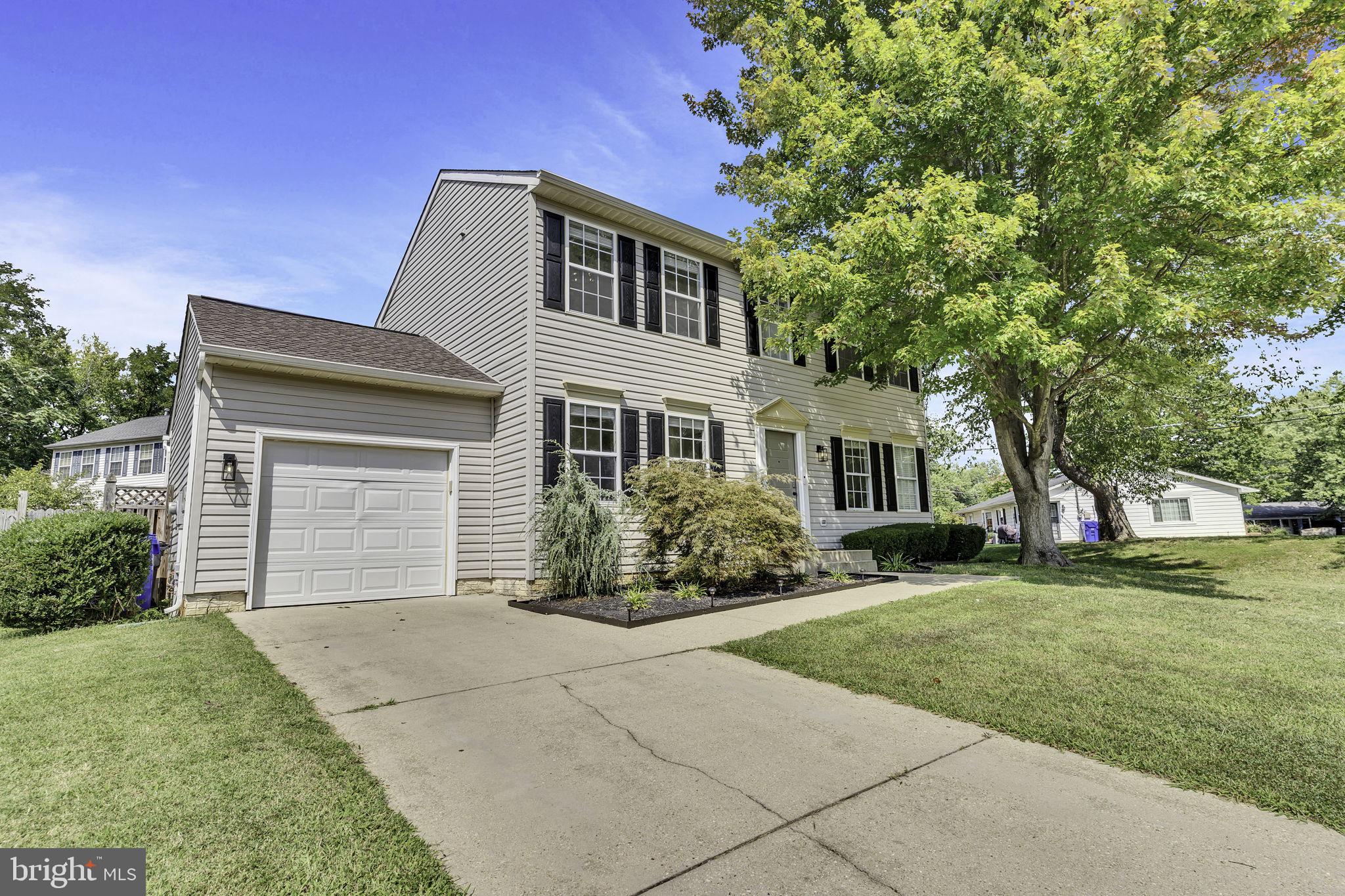 6546 Cornell Road Bryans Road, MD 20616 - Photo 1 of 35 a front view of a house with a garden and trees