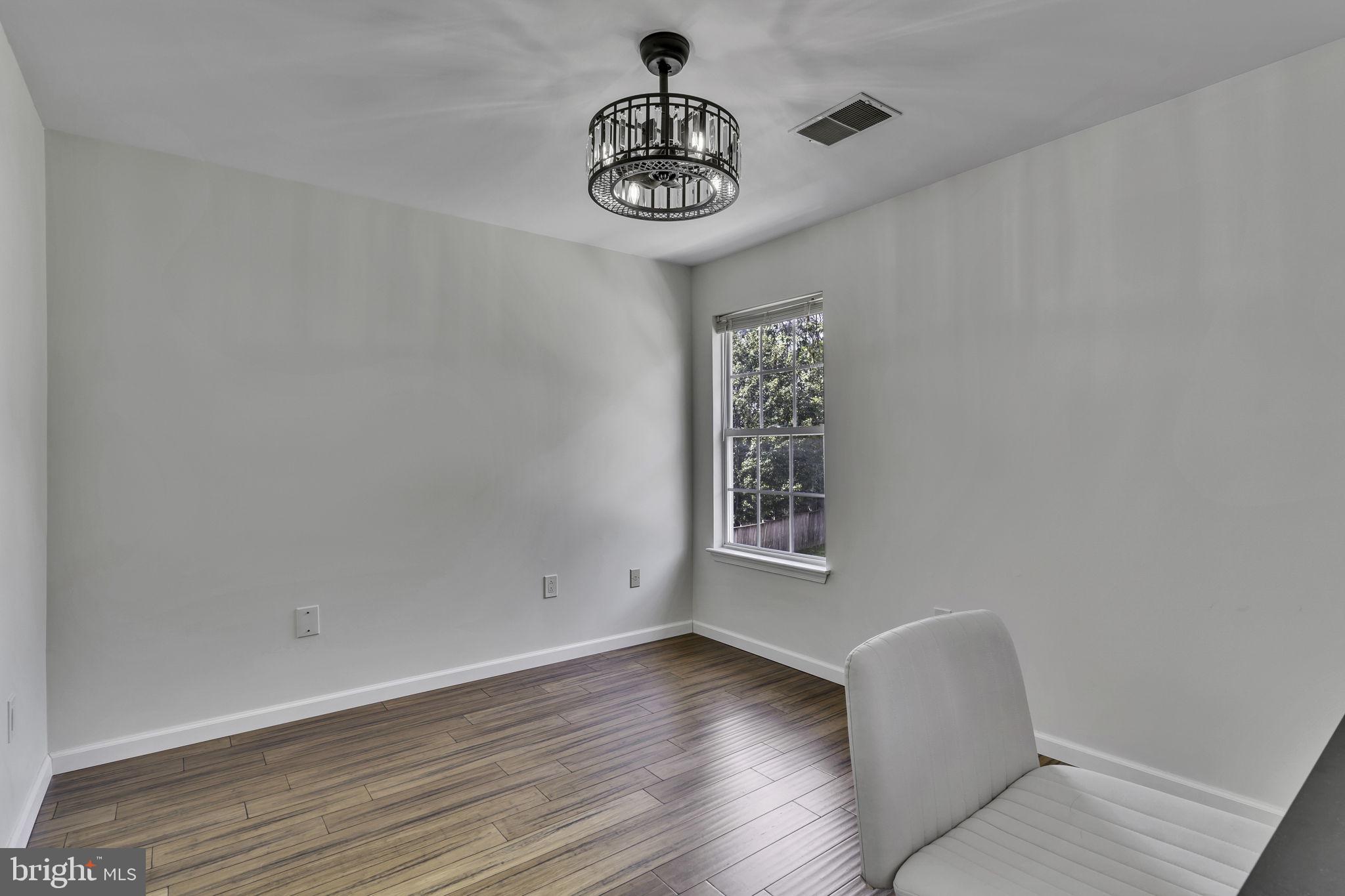 6546 Cornell Road Bryans Road, MD 20616 - Photo 17 of 35 a view of a room with wooden floor fan and windows