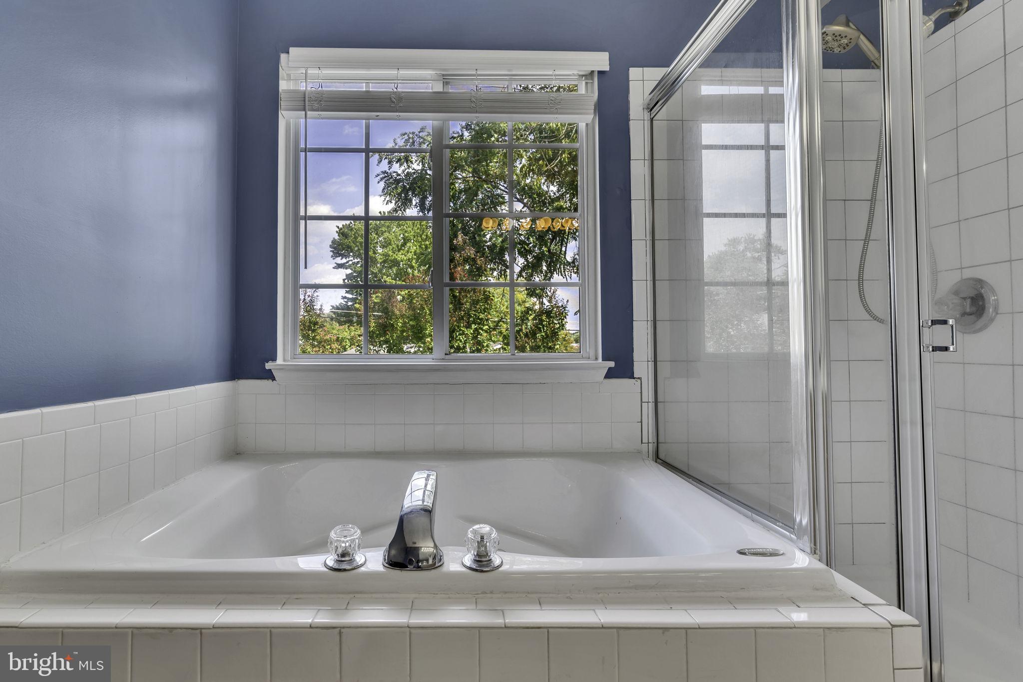 6546 Cornell Road Bryans Road, MD 20616 - Photo 27 of 35 a bath tub sitting in a bathroom next to a window