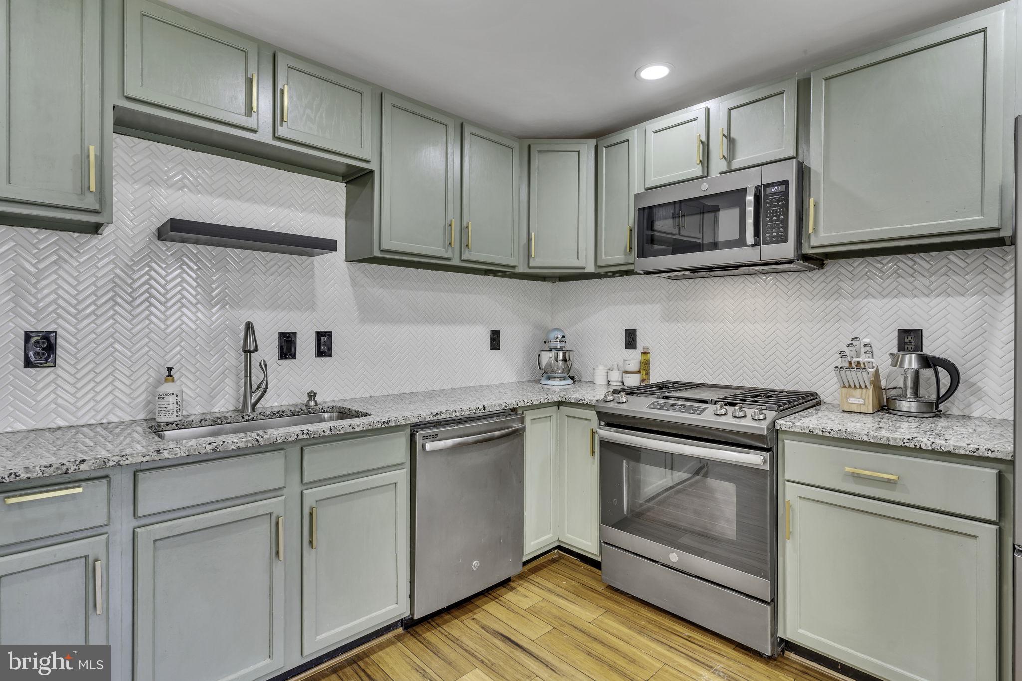 6546 Cornell Road Bryans Road, MD 20616 - Photo 3 of 35 a kitchen with cabinets stainless steel appliances a sink and dishwasher