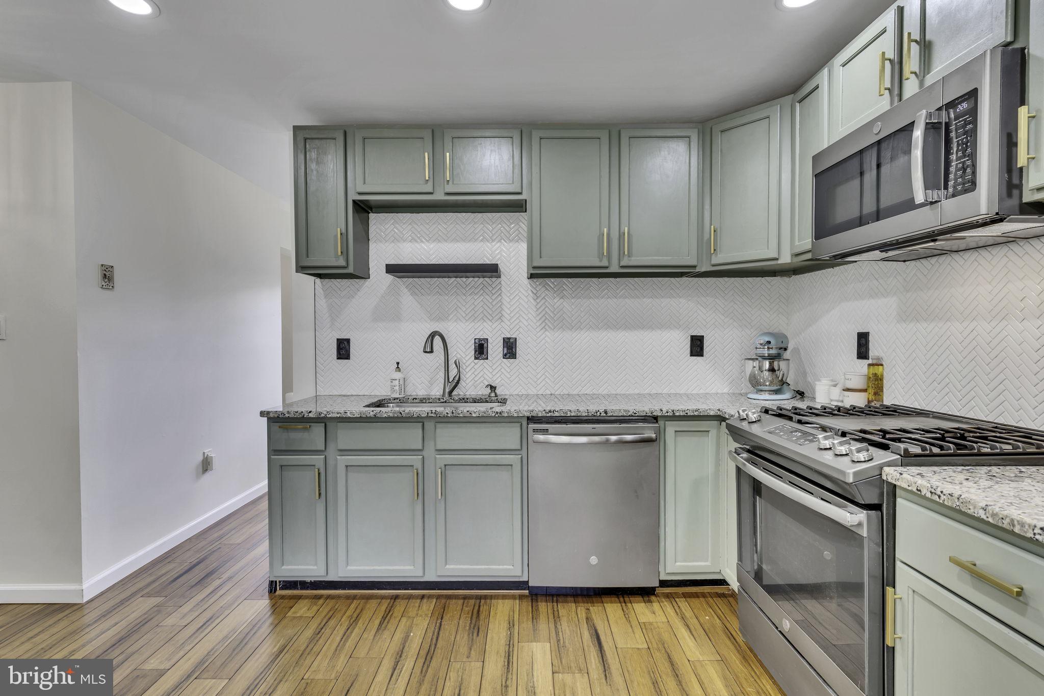 6546 Cornell Road Bryans Road, MD 20616 - Photo 9 of 35 a kitchen with stainless steel appliances granite countertop a sink stove and cabinets