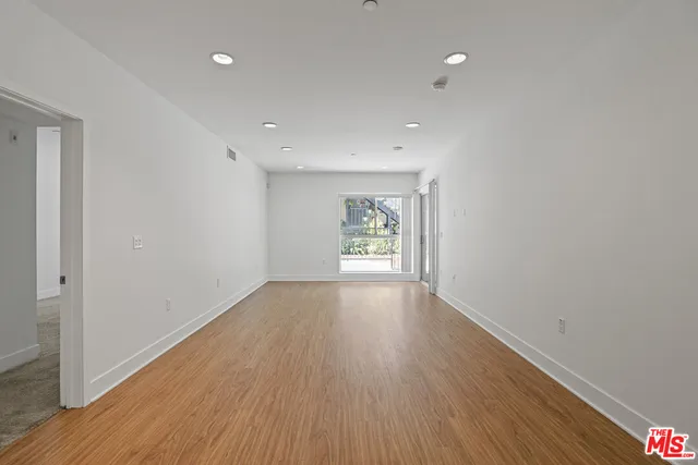 a view of wooden floor and windows in an empty room