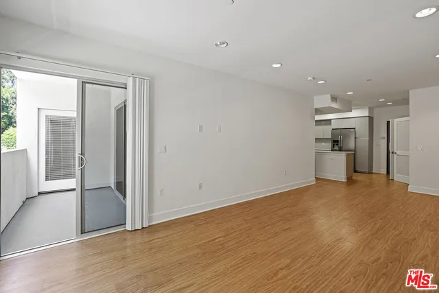 a view of a kitchen with a refrigerator and a sink