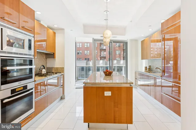 a kitchen with a stove a refrigerator and wooden cabinets