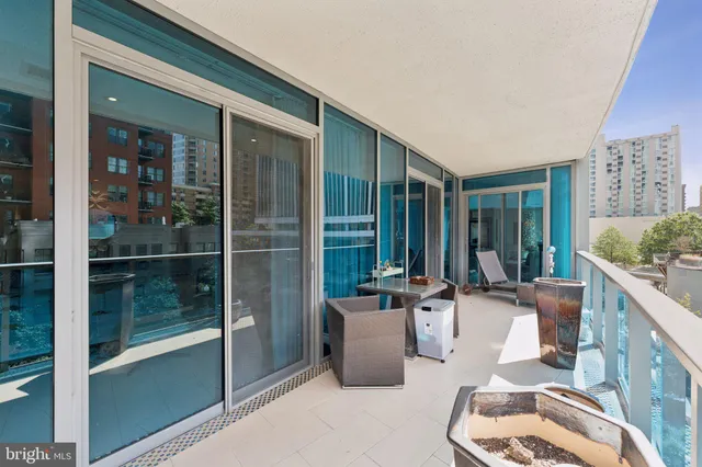 a view of balcony with a large window and wooden fence