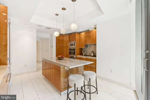 a kitchen with stainless steel appliances granite countertop a sink and cabinets