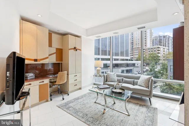 a living room with furniture a rug and a flat screen tv