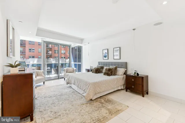 a bedroom with a double bed and a dresser