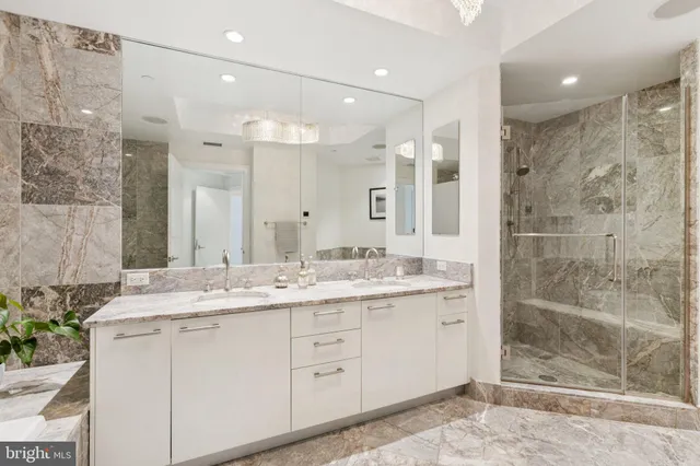 a bathroom with a tub sink shower and mirror