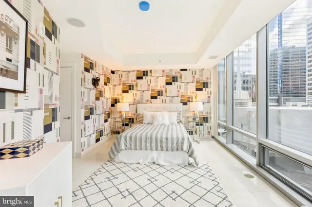 a bedroom with a bed and a bookshelf with wooden floor