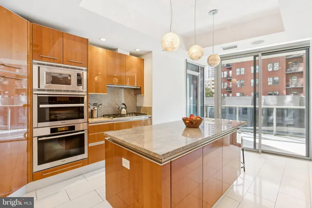 a kitchen with stainless steel appliances granite countertop a stove and a refrigerator