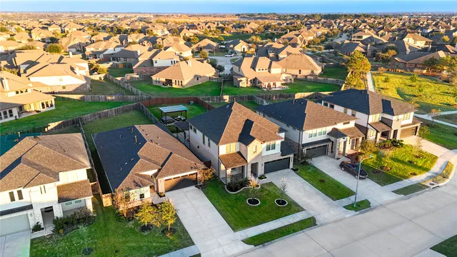 an aerial view of a house with backyard space and balcony