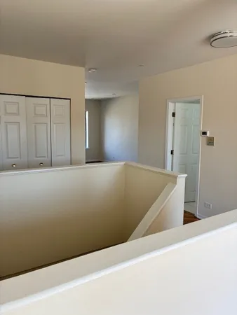 a view of hallway with bathroom and a sink